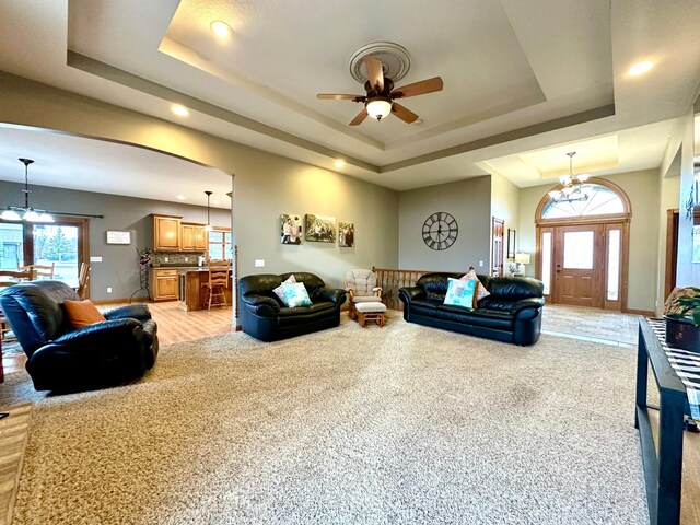 13943 Sundberg Ave, Graham Lakes Twp, MN 56131 - living room with a tray ceiling, a ceiling fan, recessed lighting, light colored carpet, and baseboards