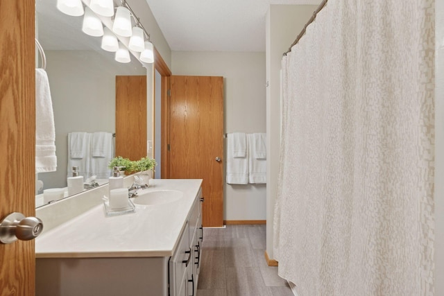 full bathroom featuring baseboards and vanity