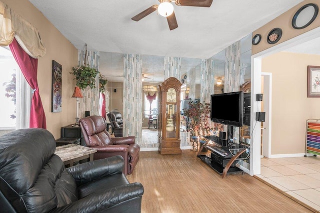 living room with wood-type flooring and ceiling fan