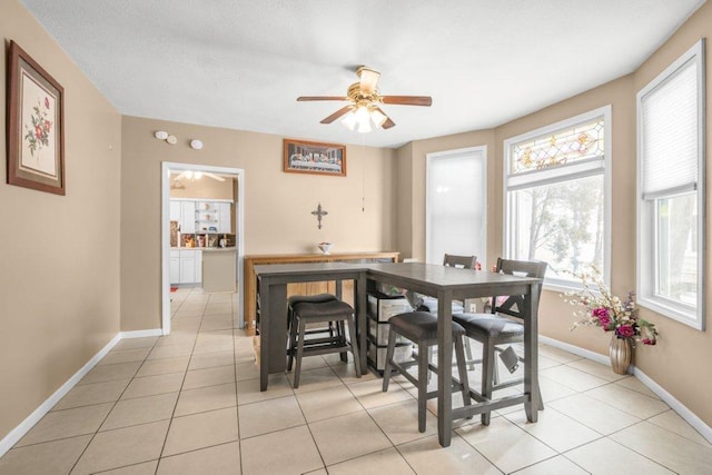 dining area with light tile patterned floors and ceiling fan