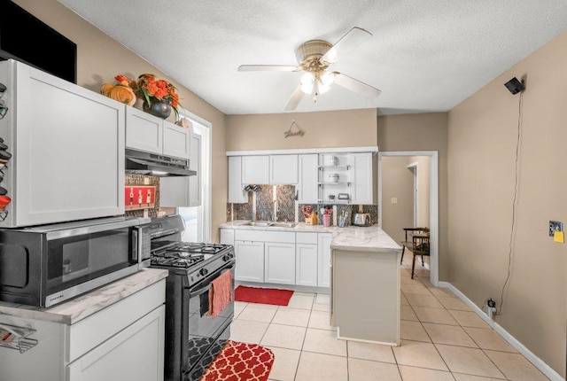 kitchen featuring sink, white cabinetry, light tile patterned floors, black gas stove, and decorative backsplash