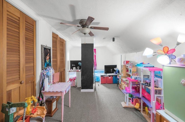 playroom with vaulted ceiling, ceiling fan, and carpet