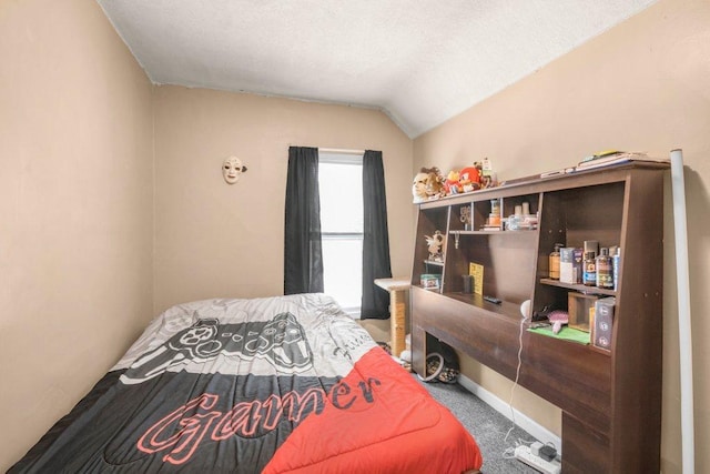 carpeted bedroom with lofted ceiling