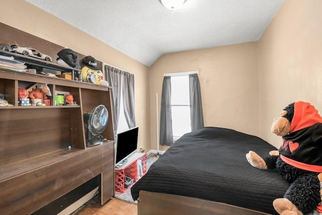 bedroom with light hardwood / wood-style flooring and vaulted ceiling