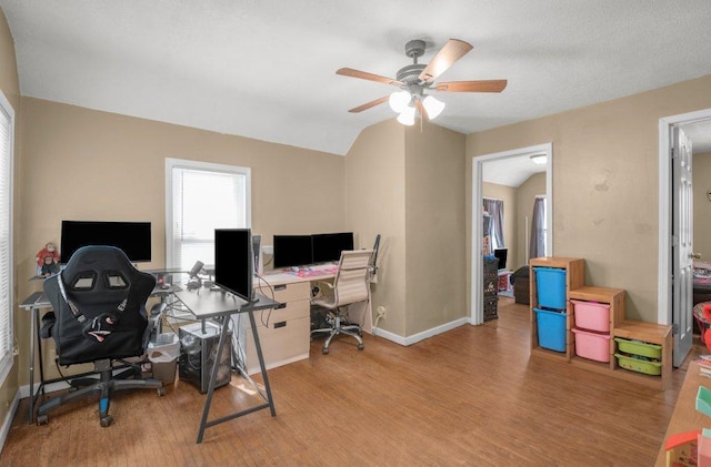 office space featuring vaulted ceiling, ceiling fan, and light wood-type flooring