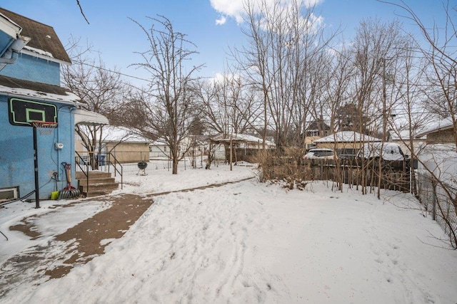 view of yard layered in snow