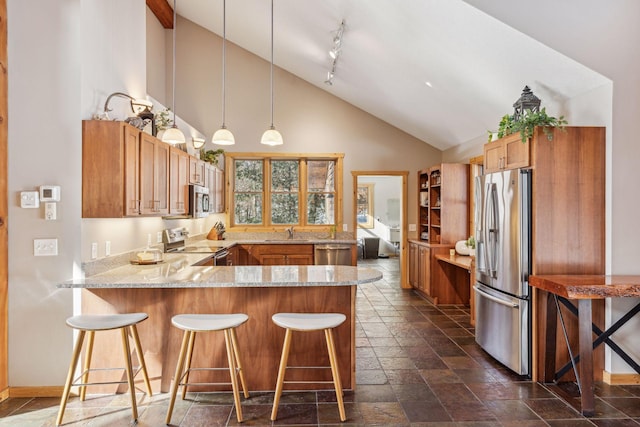 kitchen with decorative light fixtures, a breakfast bar, kitchen peninsula, and appliances with stainless steel finishes