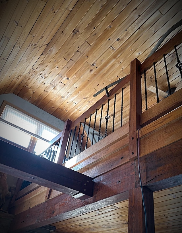 stairway featuring vaulted ceiling and wooden ceiling