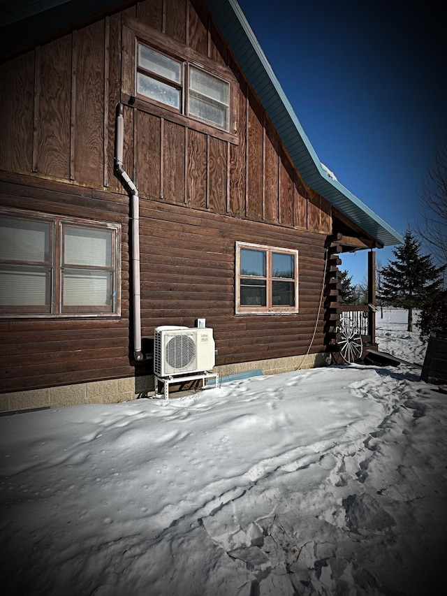 view of snowy exterior featuring ac unit