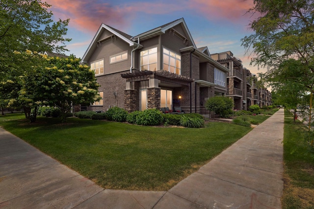 view of front of house with a front yard and brick siding