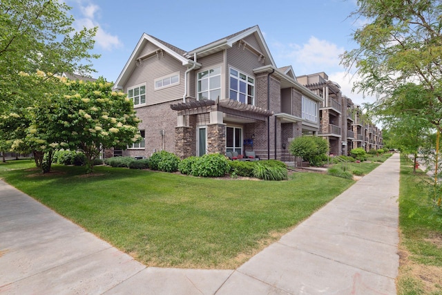 view of front of property with brick siding and a front lawn