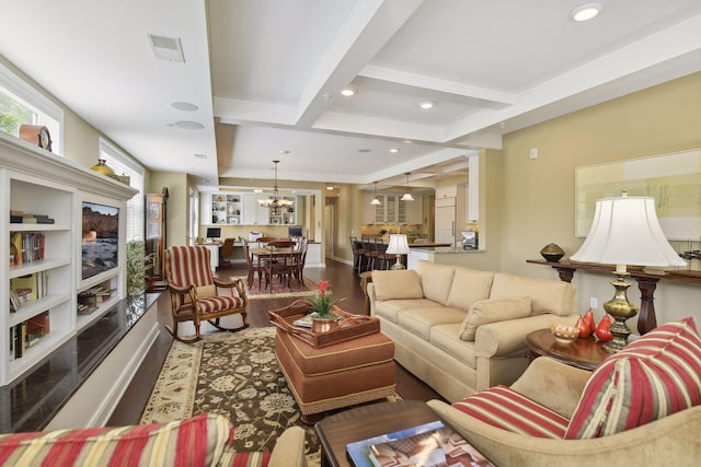 living area featuring a chandelier, recessed lighting, coffered ceiling, wood finished floors, and beamed ceiling