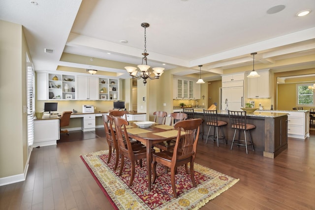 dining area featuring a chandelier, visible vents, beam ceiling, built in desk, and dark wood finished floors