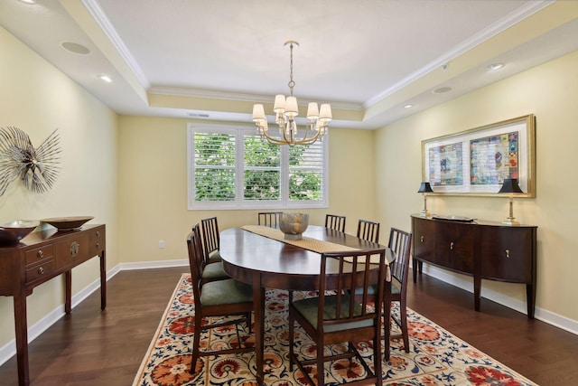 dining room with a tray ceiling, dark wood-type flooring, and ornamental molding