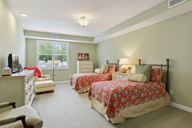 bedroom featuring baseboards, visible vents, and light colored carpet