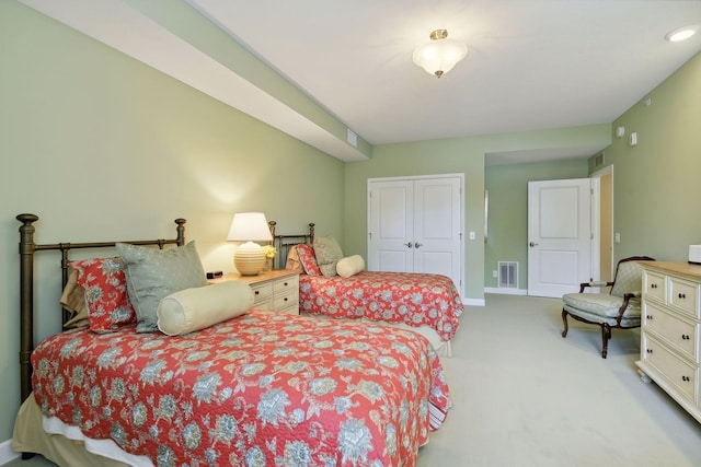 bedroom with carpet, a closet, visible vents, and baseboards