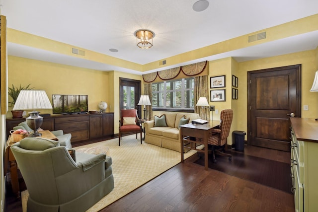 living room with visible vents and wood finished floors