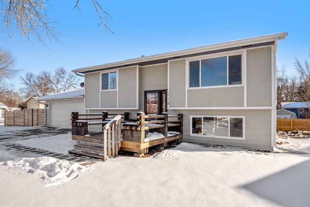 snow covered property featuring a garage