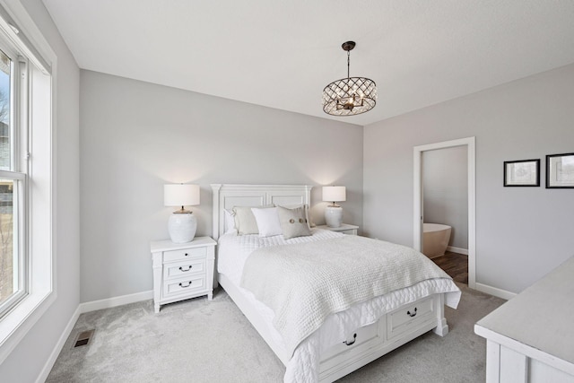 bedroom featuring visible vents, baseboards, and multiple windows