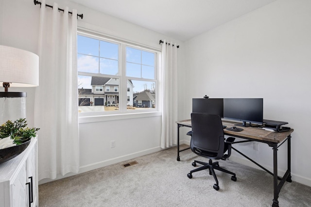 carpeted office space with visible vents and baseboards