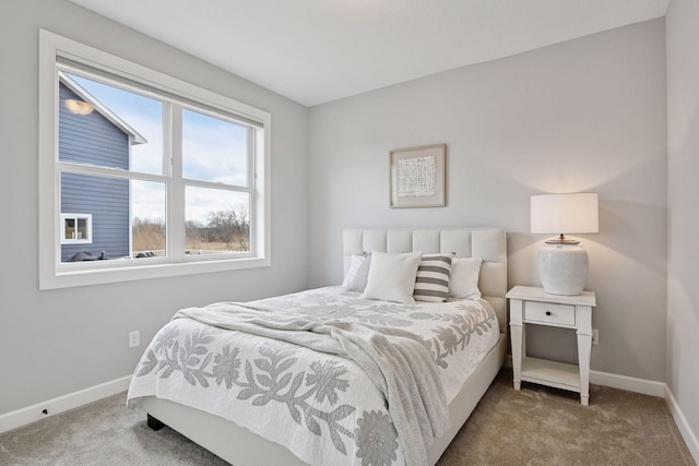 bedroom with carpet floors and baseboards