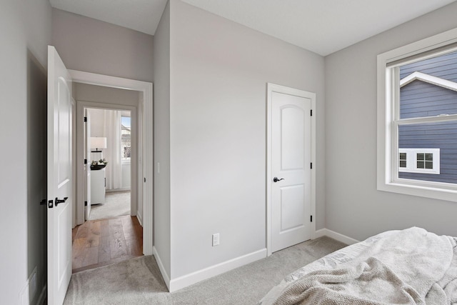 carpeted bedroom featuring baseboards