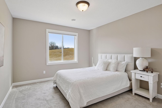 bedroom with carpet flooring and baseboards