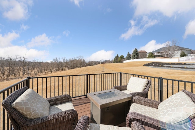 deck featuring a fire pit and a rural view