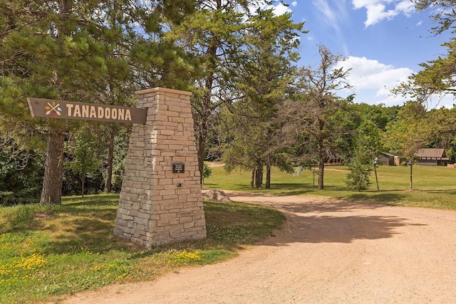 view of home's community featuring a yard and driveway