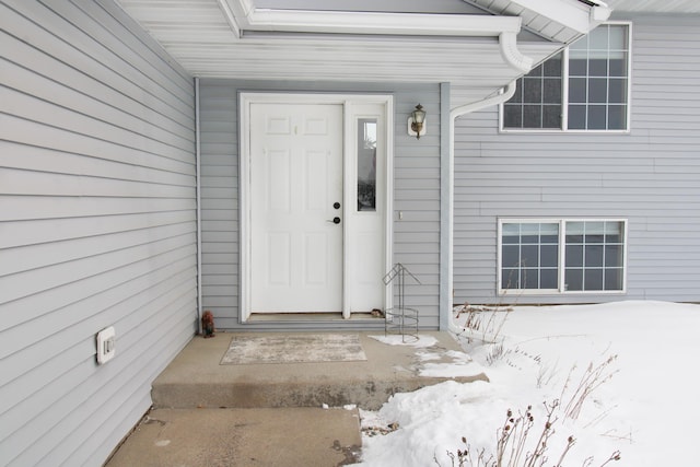 view of snow covered property entrance