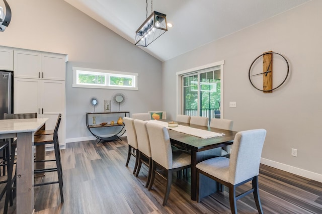 dining space with high vaulted ceiling, baseboards, and dark wood-style flooring