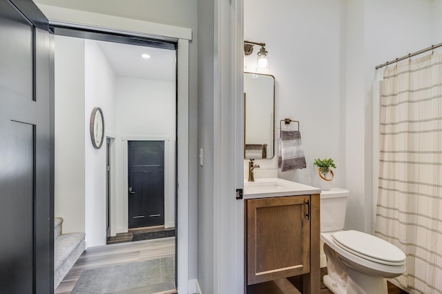 bathroom featuring vanity and toilet