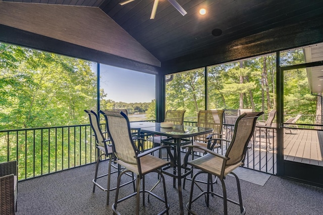 sunroom with a ceiling fan and vaulted ceiling