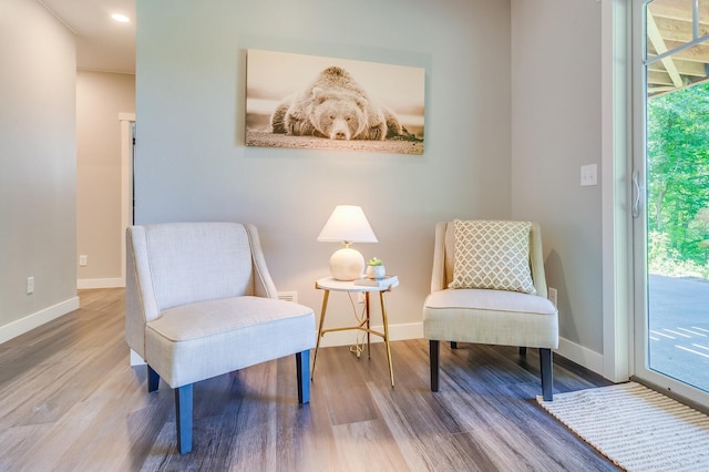 sitting room featuring baseboards and wood finished floors