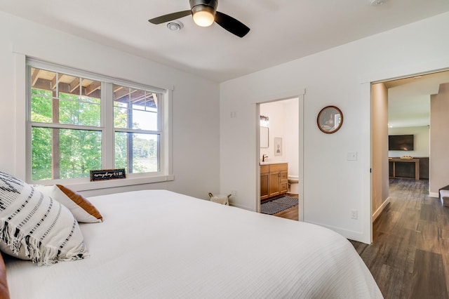 bedroom featuring dark wood-style flooring, connected bathroom, a ceiling fan, and baseboards