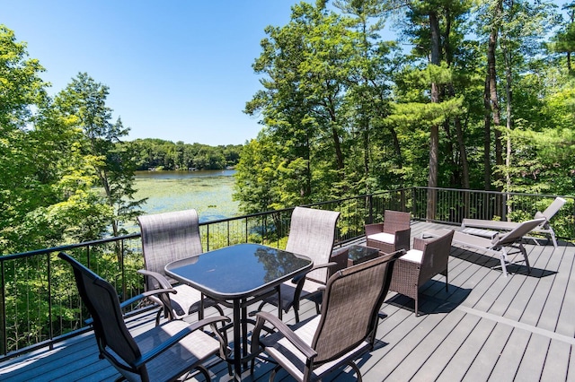 wooden deck featuring a water view and a view of trees