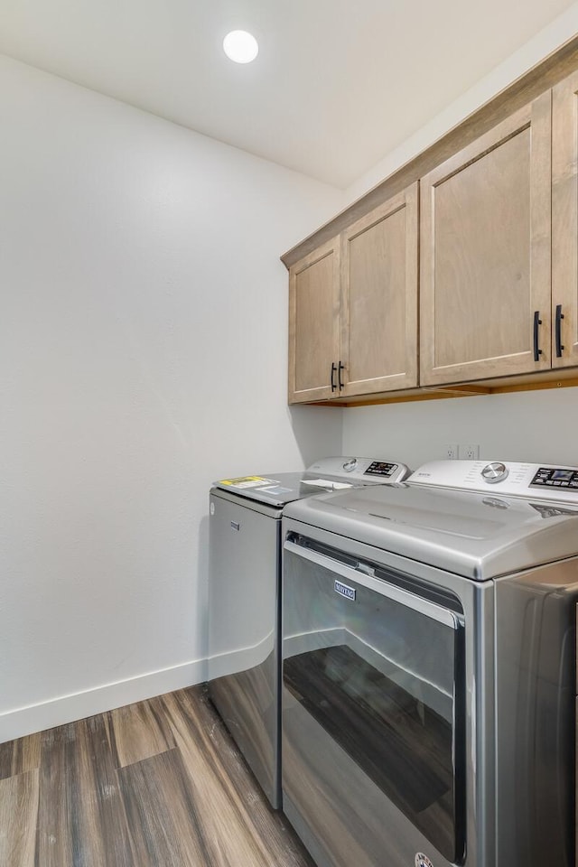 clothes washing area featuring cabinet space, baseboards, dark wood-style floors, separate washer and dryer, and recessed lighting