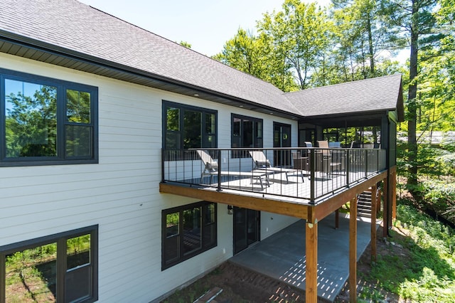 2568 28 1/4 St, Cedar Lake Twp, WI 54817 - back of house featuring a wooden deck, a patio area, and a shingled roof