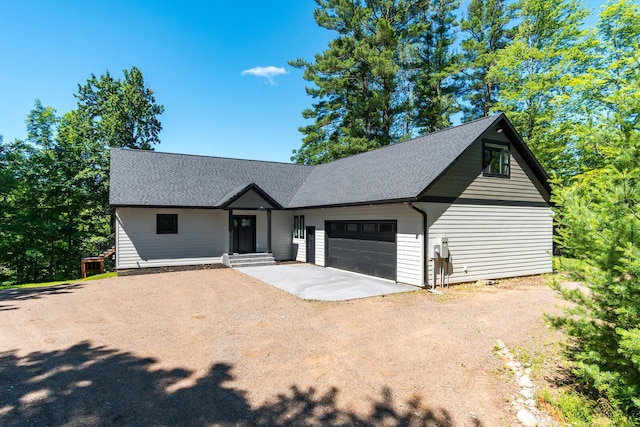 2568 28 1/4 St, Cedar Lake Twp, WI 54817 - view of front facade with driveway, roof with shingles, and a garage
