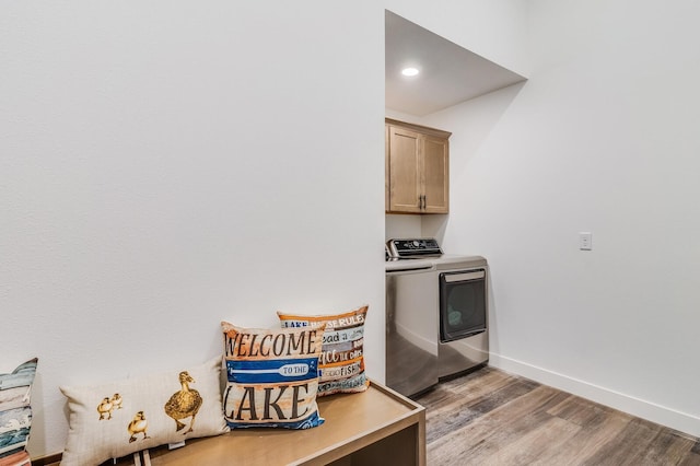 2568 28 1/4 St, Cedar Lake Twp, WI 54817 - clothes washing area featuring washer and dryer, cabinet space, light wood finished floors, baseboards, and recessed lighting