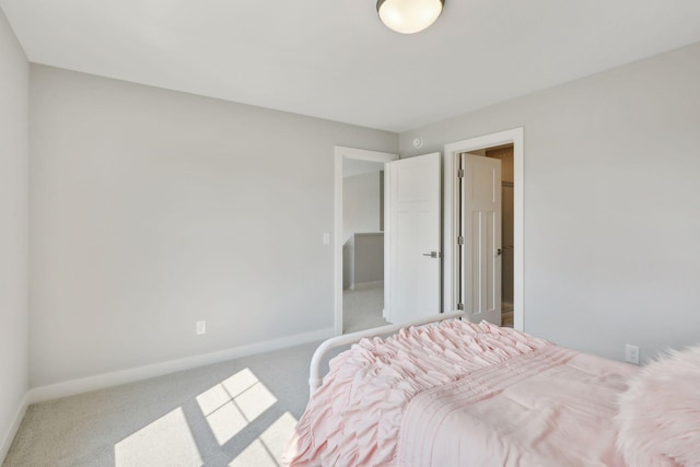 carpeted bedroom with baseboards