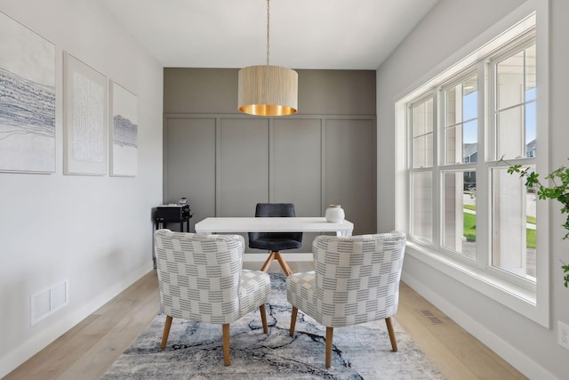 dining room featuring plenty of natural light and light hardwood / wood-style floors