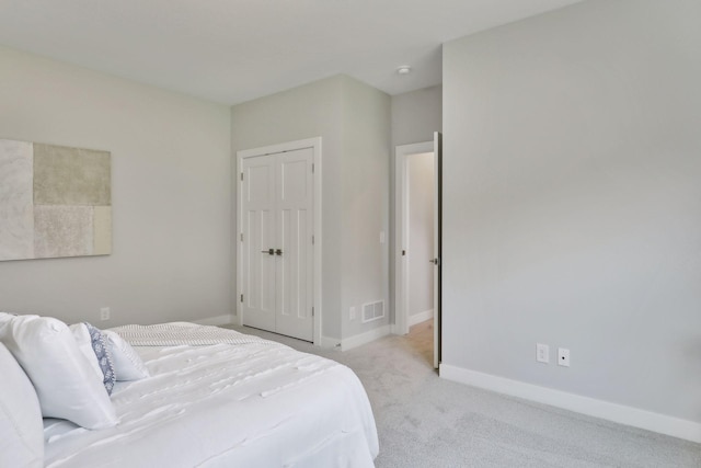 carpeted bedroom featuring a closet