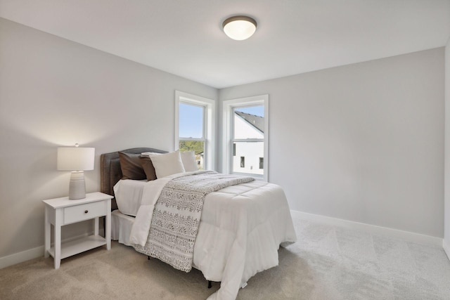 bedroom featuring light carpet