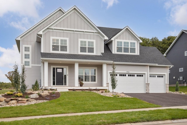 craftsman-style home with a garage and a front lawn