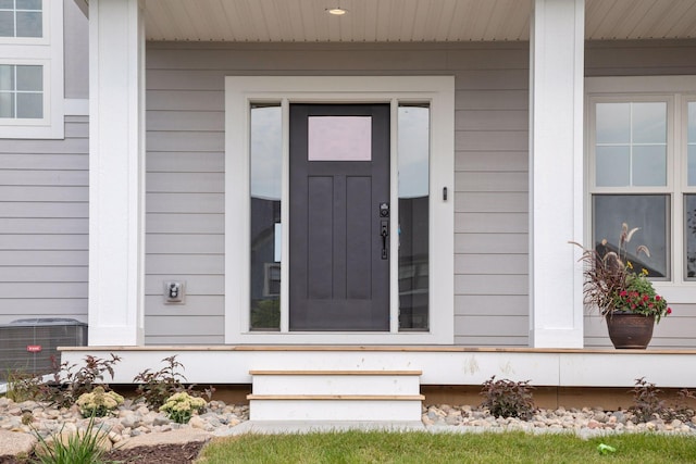 view of exterior entry with central AC unit