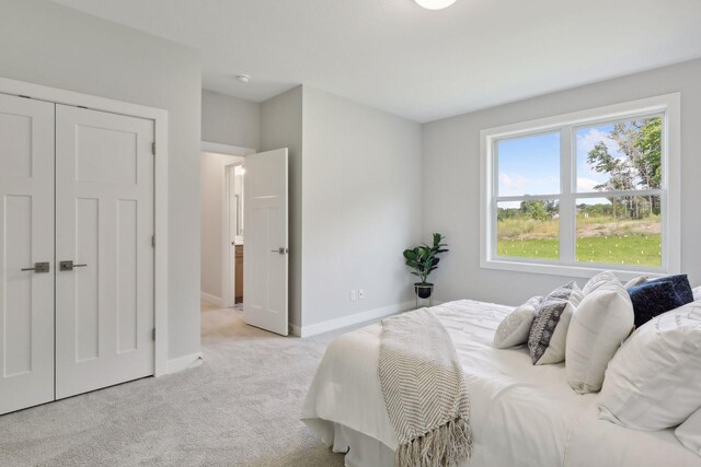 carpeted bedroom featuring baseboards