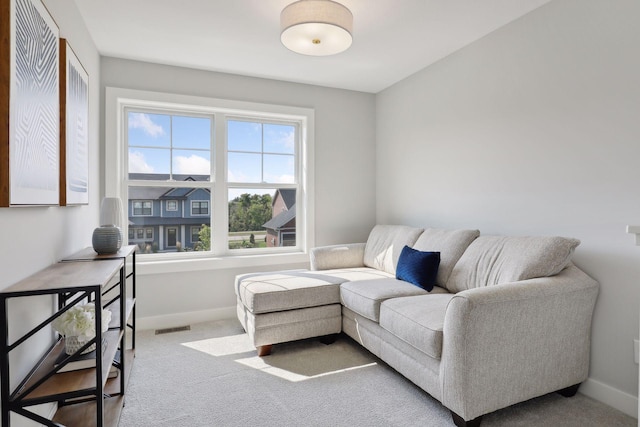 living area with carpet flooring, baseboards, and visible vents