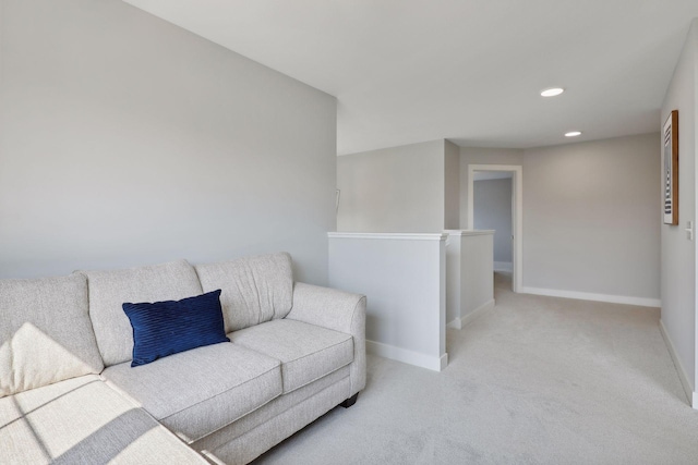 carpeted living area with recessed lighting and baseboards