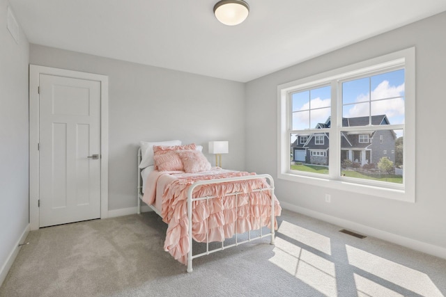 bedroom with visible vents, baseboards, and carpet floors